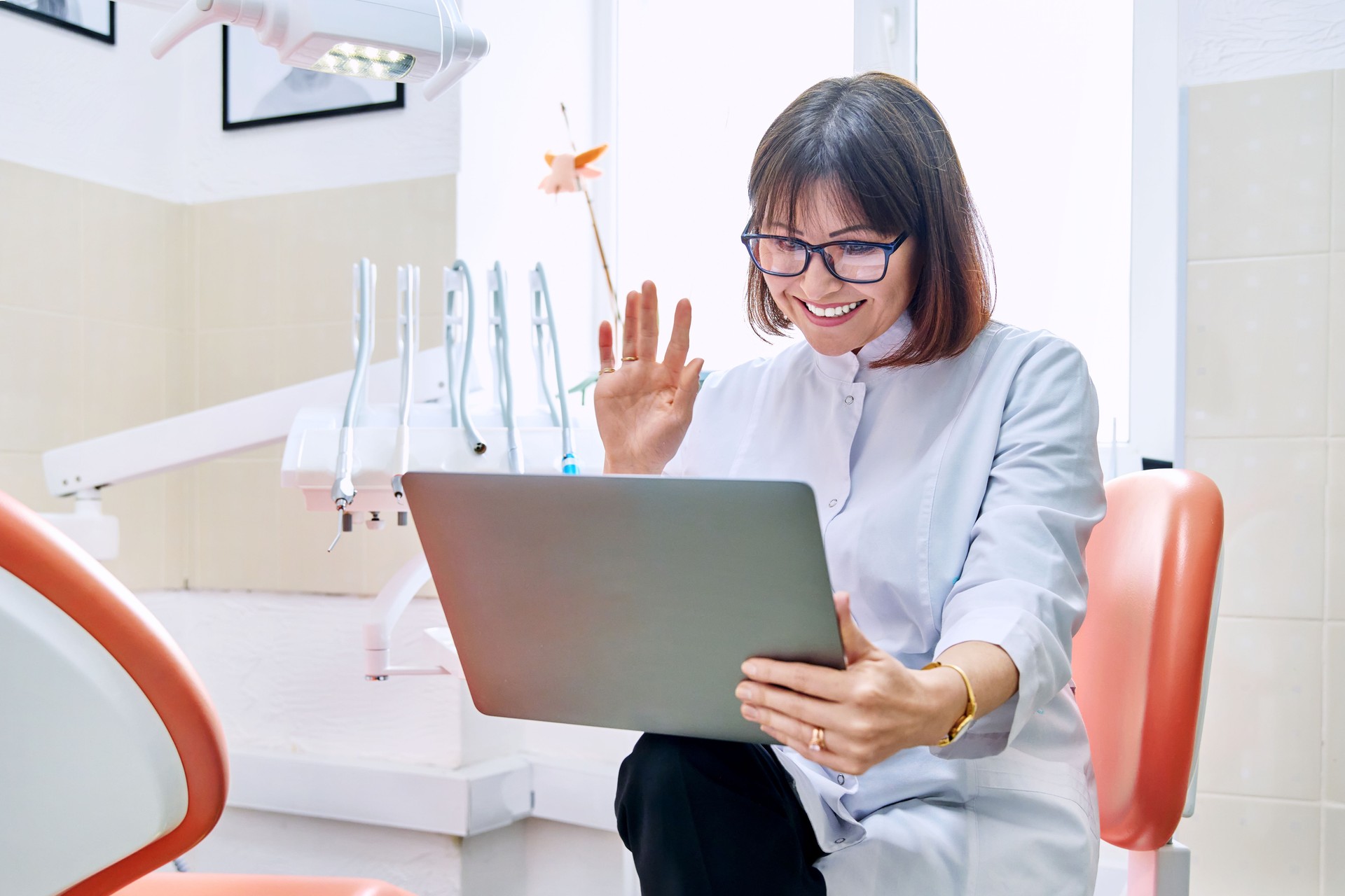 Online consultation, doctor help in clinic using laptop.