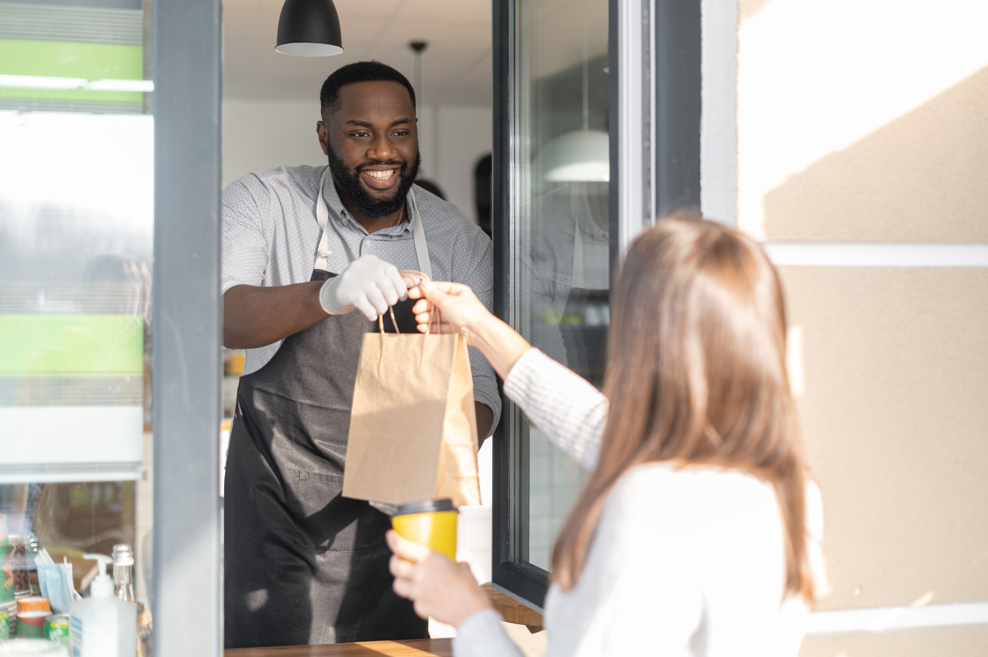 An African waiter is serving a guest